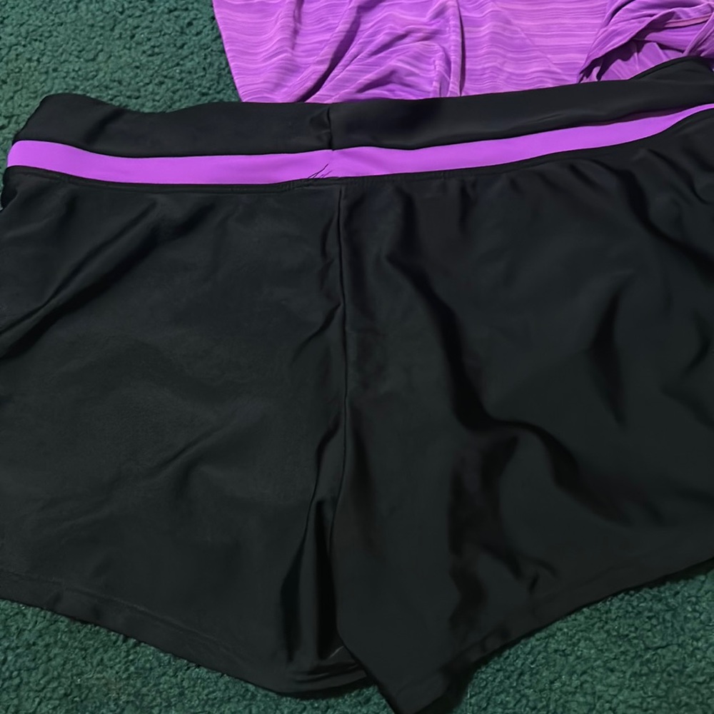 Selling purple swimsuit that comes with matching shorts.